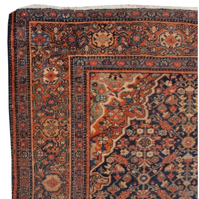 An early 20th century Persian Sarouk Farahan rug with a wonderful and intricately woven central medallion on a field of...