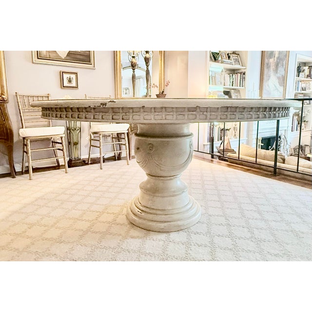 Old World Guildmaster round solid wood dining table features an elegant substantial carved pedestal base with graceful...