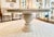Old World Guildmaster round solid wood dining table features an elegant substantial carved pedestal base with graceful...