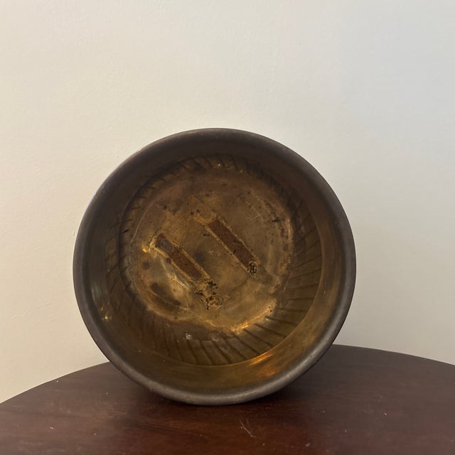 Decorative 1980s vintage brass cachepot or jardinière featuring a rounded form, three ornate feet and handsome gadrooned...