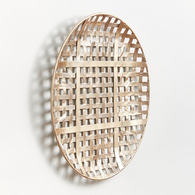 With a sloping edge and stamped iron texture, iron strands are woven together to create a dynamic wall feature. This...