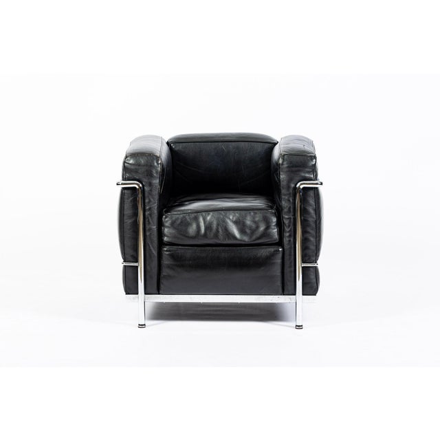 This authentic LC2 Petit Modele black leather armchair originally designed by Le Corbusier, Charlotte Perriand and Pierre...
