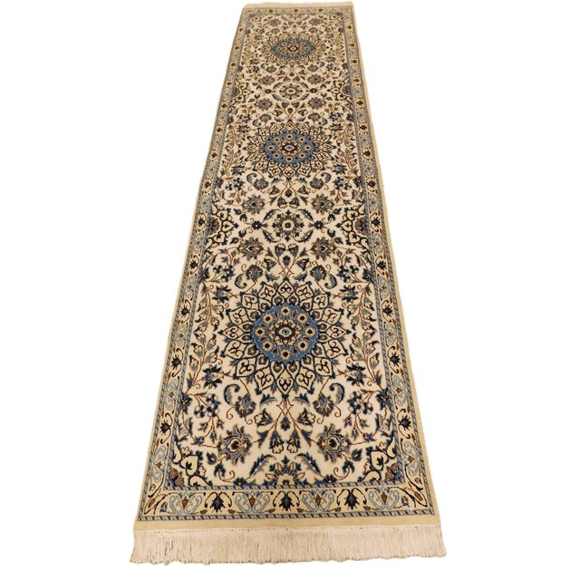 Triple medallion on a cream field surrounded by floral decoration. Narrow border displaying stylized floral motifs. Soft...