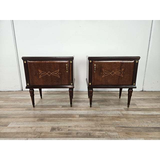 An elegant pair of vintage oak nightstands dating back to the 1960s, characterized by refined decorative taste and...