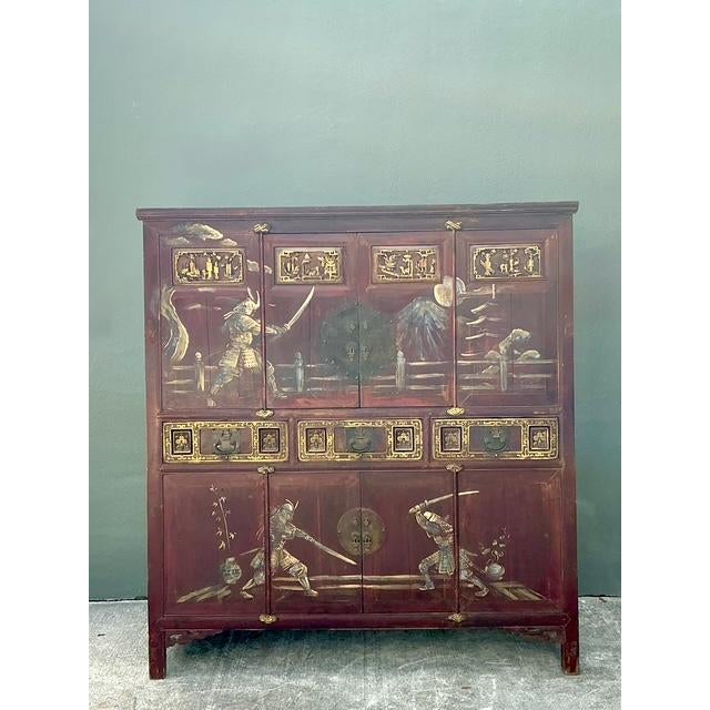 This monumental antique cabinet is a masterpiece of East Asian storytelling and artisanal craftsmanship. The facade is...