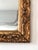 Antique small full-length wall mirror with a hand-carved giltwood frame, made in Belgium around 1900. The design shows...