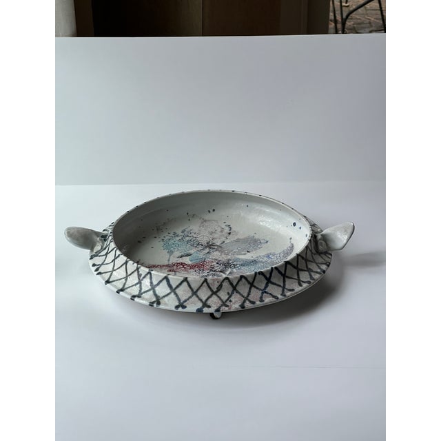 Beautiful blue and white with red and grey accent handmade pottery bowl with handles. This piece can be hung on the wall...