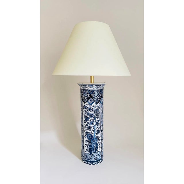 A 20th century pair of cylinder shaped table lamps, made from two elegant delft vases. The lamps are beautifully decorated...
