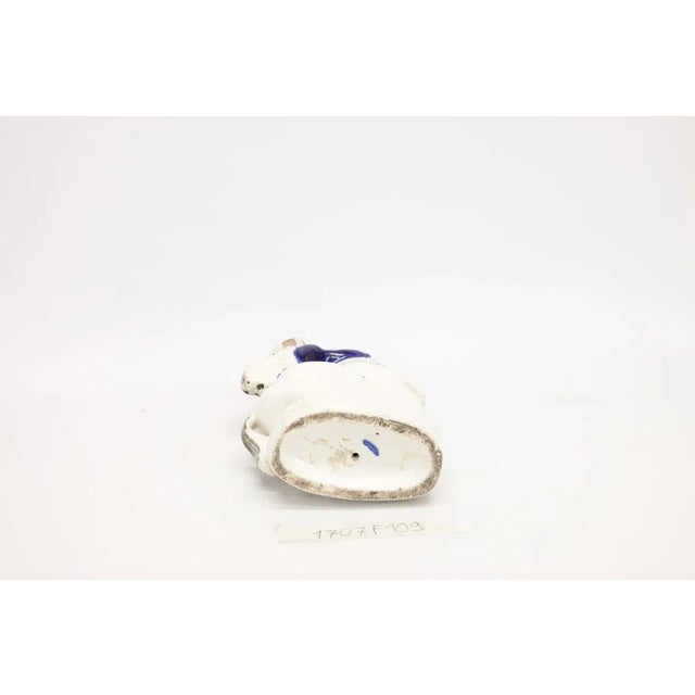 Ceramic statue ''of a woman knight on horseback'' with a blue mark on the bottom that dates back to the factory of English...