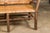 An Old Hickory hoop settee from the mid 20th century with woven rattan back and seat. This mid-20th-century Old Hickory...