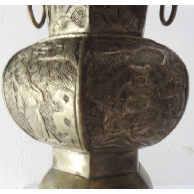 These vases are very detailed, depicting Oriental scenes. They are made of bronze with an overlay of tin. Each has two...