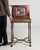 Inlaid walnut side table in Rich Walnut Brown. The rich walnut brown surface highlights brass-inlaid top, cross-stretcher...