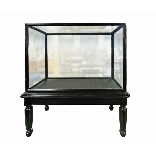 Early 20th century, black painted wood and glass English showcase. Glass doors on sides. We also have an identical,...