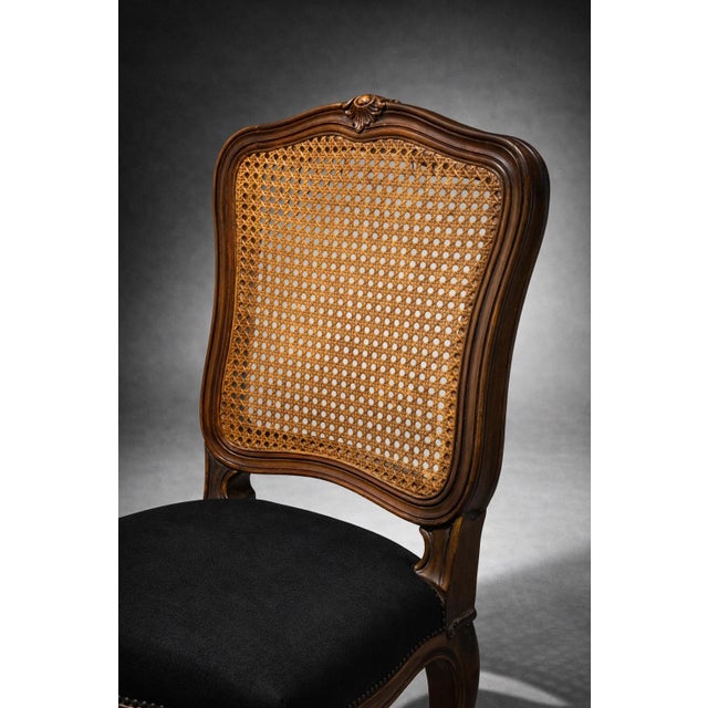 A refined pair of French Provincial cane-back chairs, thoughtfully refreshed in a warm Old Chapel walnut satin finish and...