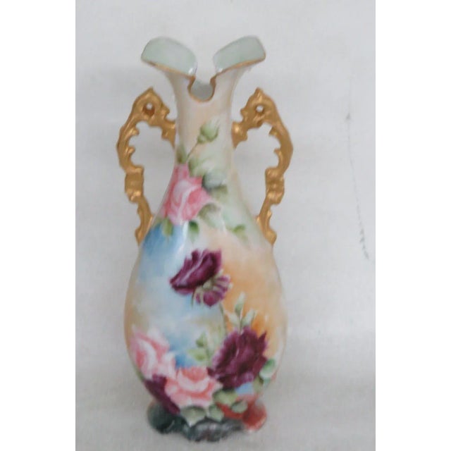 This charming vase is made out of porcelain. This piece is made in a beautiful orange and blue gradient color scheme with...