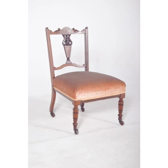 Lady's chair in rosewood. The backrest is decorated with carvings and marquetry, featuring a central openwork element in...
