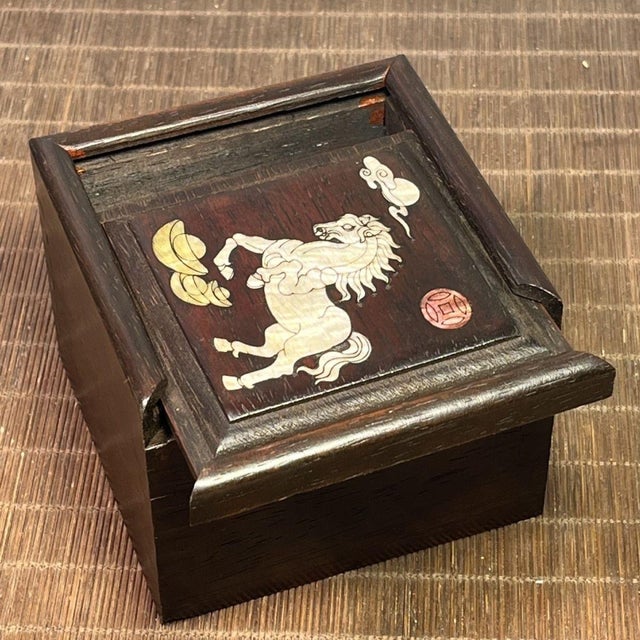 A charming Chinese round keepsake box carved from rosewood (huali wood), its lid adorned with a luminous mother-of- pearl...