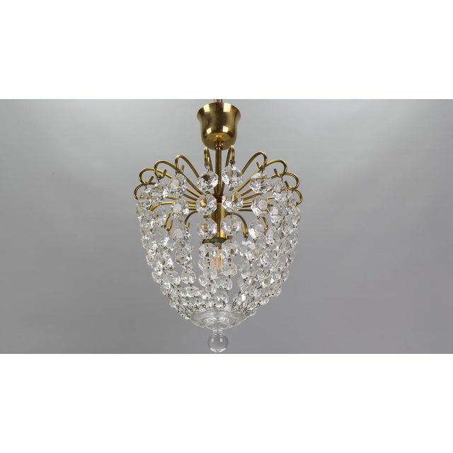 Crystal glass and brass ceiling light from circa the 1970s, Germany. Adorable and compact basket-shaped single-light...