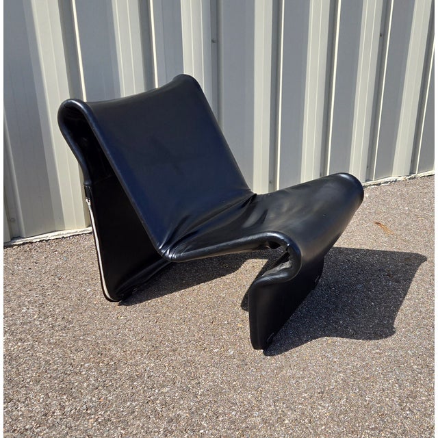 The "099" Easy Chair Attributed to Jan Dranger and Johan Huldt. This chair has a very unique M shaped curve. It is encased...