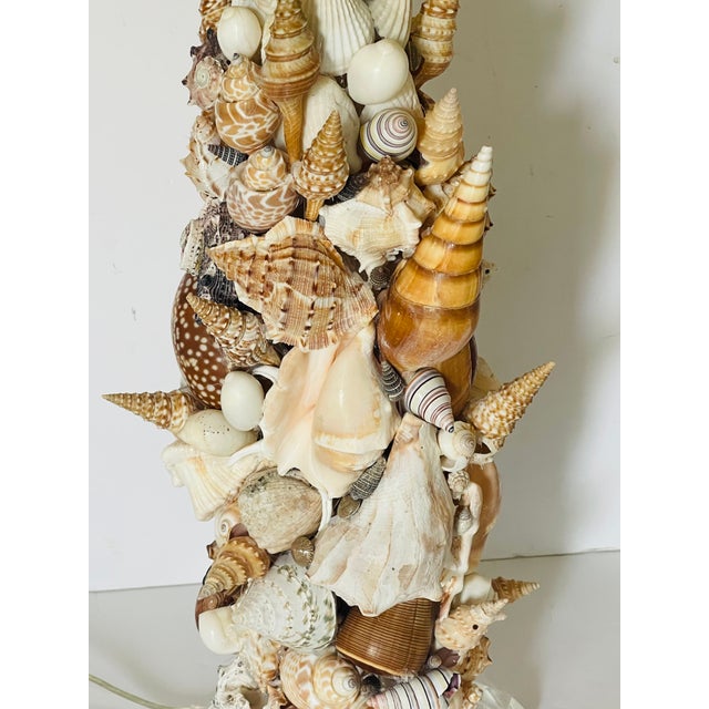Marine World Grotto style pair of table lamps richly encrusted with sea shells .