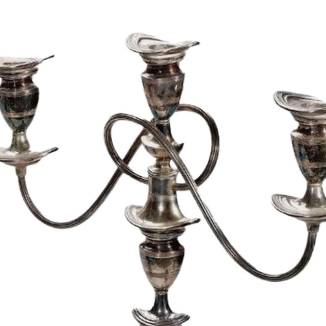 A stately pair of early 20th-century silverplate candelabra, each of tapering columnar form with elegant three-arm...