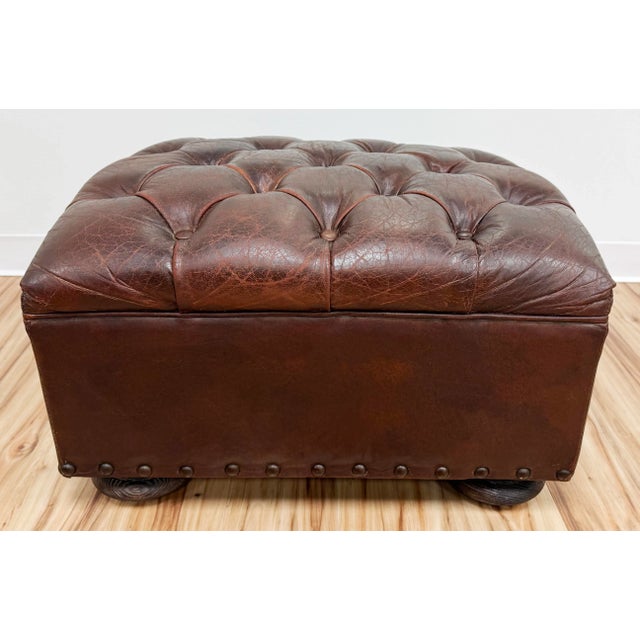 Vintage seasoned Restoration Hardware tufted leather ottoman. Features iconic and enduring style and is masterfully...