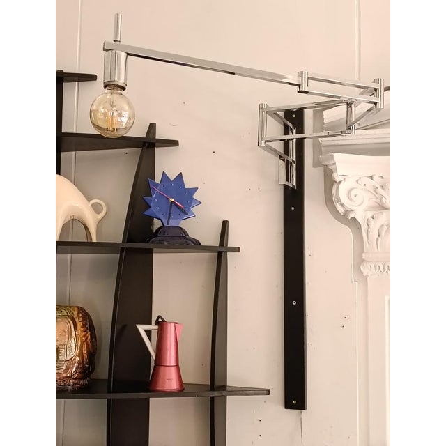 A wall lamp in chrome-plated metal designed by Goffredo Reggiani for the Reggiani company. The ‘pantograph’ or accordion-...