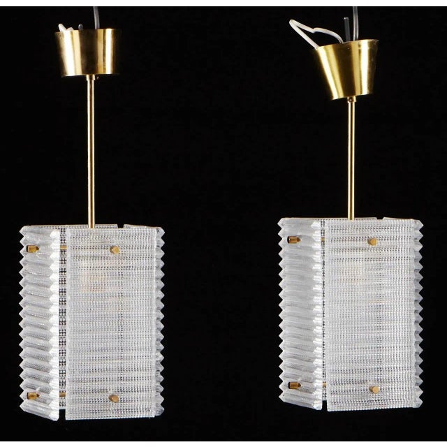 A pair of pendants by Orrefors, Sweden, circa 1960. Dimension: Height 50 cm (20"). Existing European wiring, we do not...