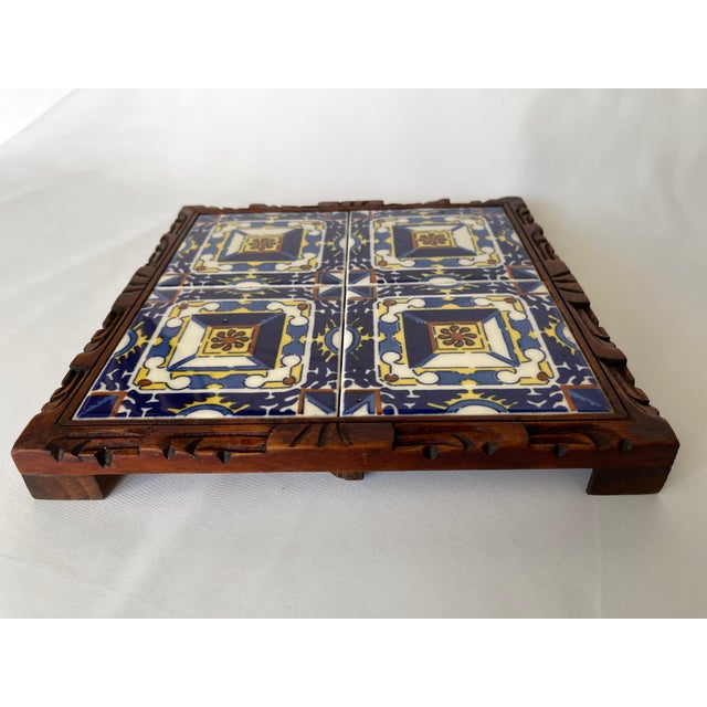 1950's Mexican tile square trivet tray with richly colored ceramic tile set in a hand carved wood framed footed base.