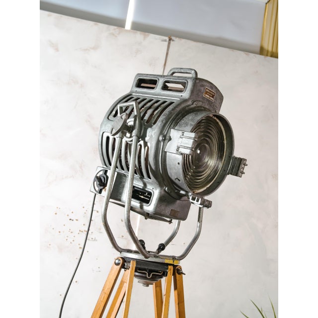 A 2kw fresnel cinema spotlight by arnold & richter of munich from the 1950s, in original grey paint, standing on an...