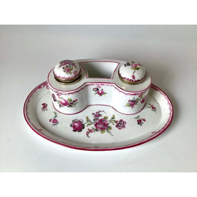A beautifully hand painted Royal Vienna double inkwell. The floral decoration on the stand and the two removable original...