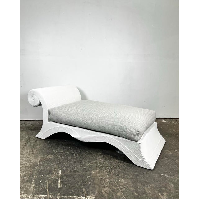 1980's Betty Cobonpue Scultura chaise lounge chair. Pencil reed rattan wide chaise with scroll back and undulating...
