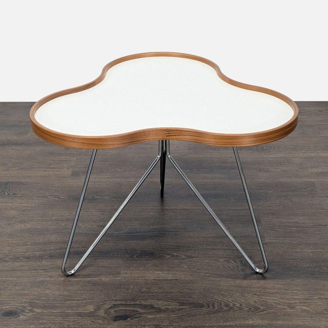 Designed by Christine Schwarzer with an organic shape and stem-like structure. The top is laminate and wood. The base is...