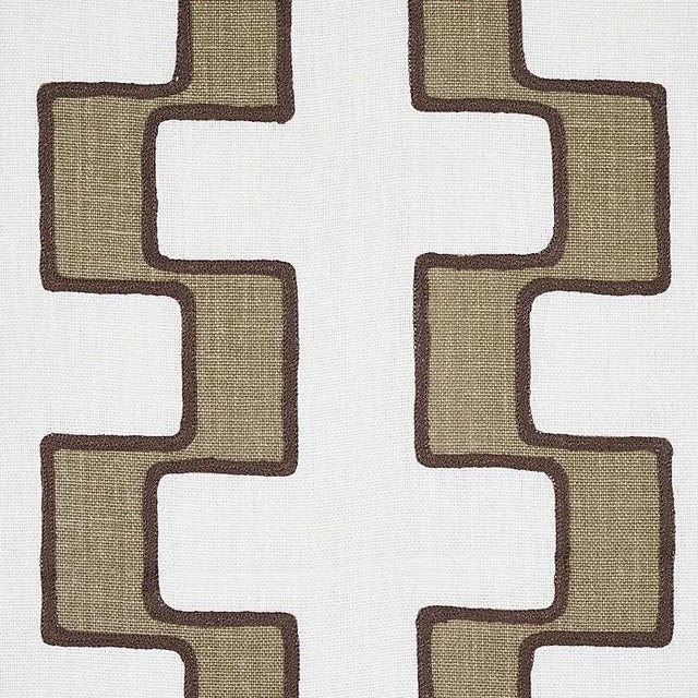 A series of stepped lines is handprinted with pigment ink on a Linen ground and then embroidered along the edges to amp up...