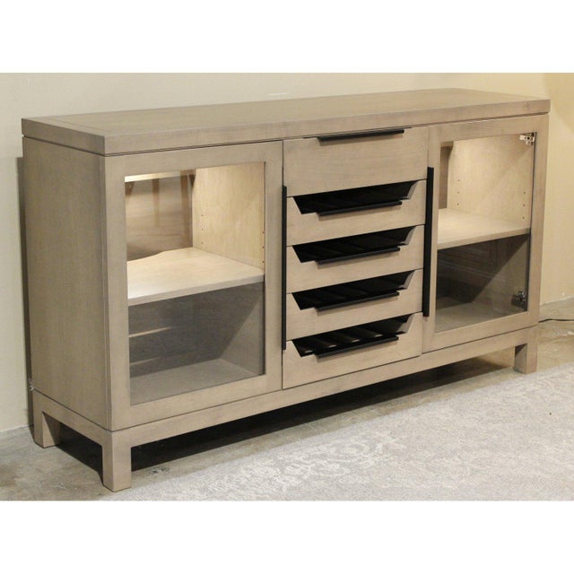 This piece is built from light-finished maple with a clean, contemporary profile and short squared legs. The center...