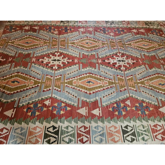 An authentic, large-scale Anatolian kilim, handwoven according to ancient Anatolian tradition and featuring a refined...