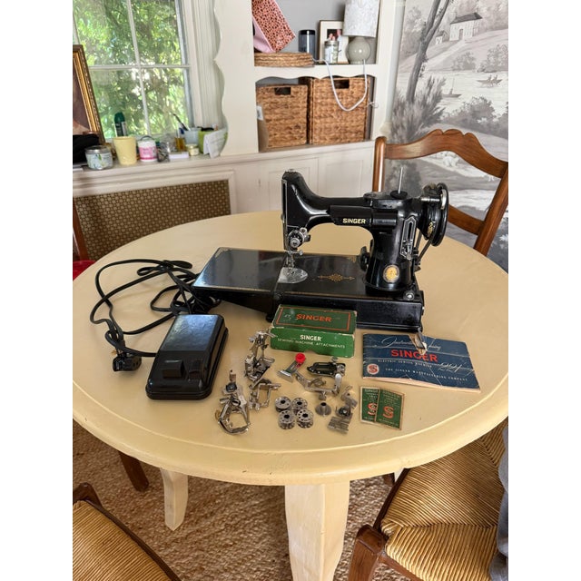 Vintage Singer Featherweight 221 portable electric sewing machine in classic black enamel with gold Singer decals and...