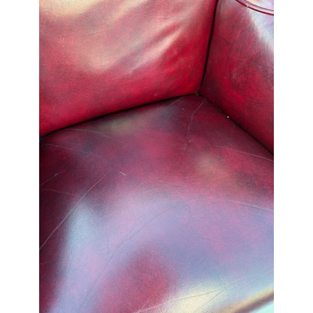 A wonderful Chippendale Style Wingback Chair. Upholstered in a burgundy / oxblood fine leather. Great styling with deep...