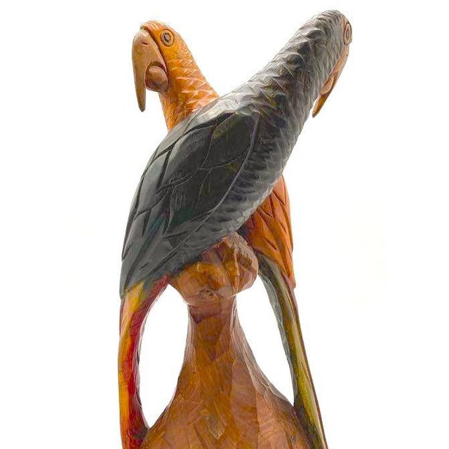 This friendly, vibrant, hand-carved wooden parrot folk art sculpture pairs native macaws and is carved from native woods,...