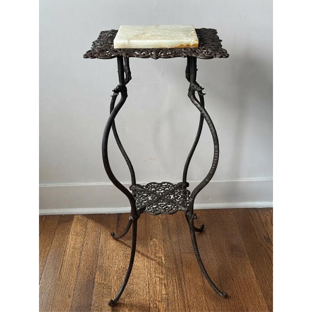 A stunning, authentic turn-of-the-century Victorian parlor plant stand or accent table. Crafted by the historic National...