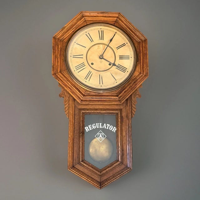 This listing is for a large antique American regulator wall clock. This clock is the “Regulator A” model by Ansonia. The...