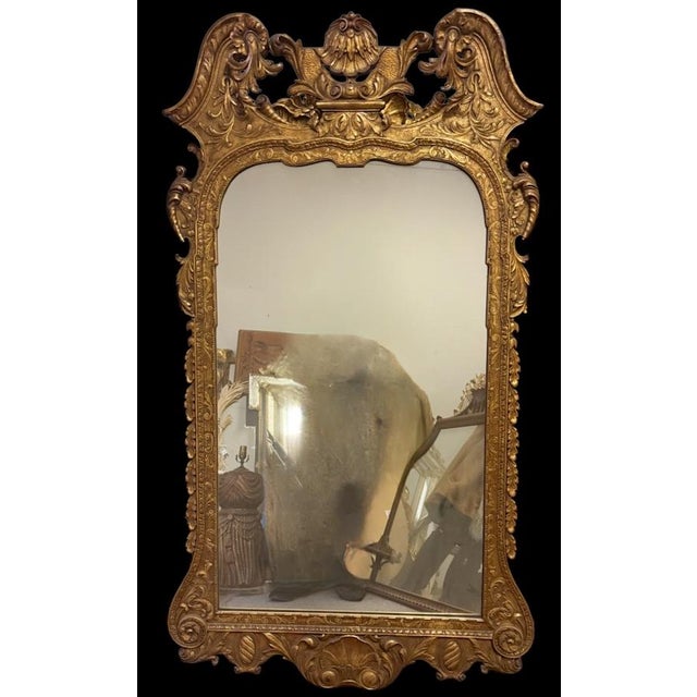 This is an Italian carved giltwood mirror with George II / Rococo styling. It has a beautiful shell form crest. It is...
