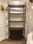 Modern Revelation Multiple Personality Etagere, brown wood with gold accents. Original retail $3981. Showroom floor sample.
