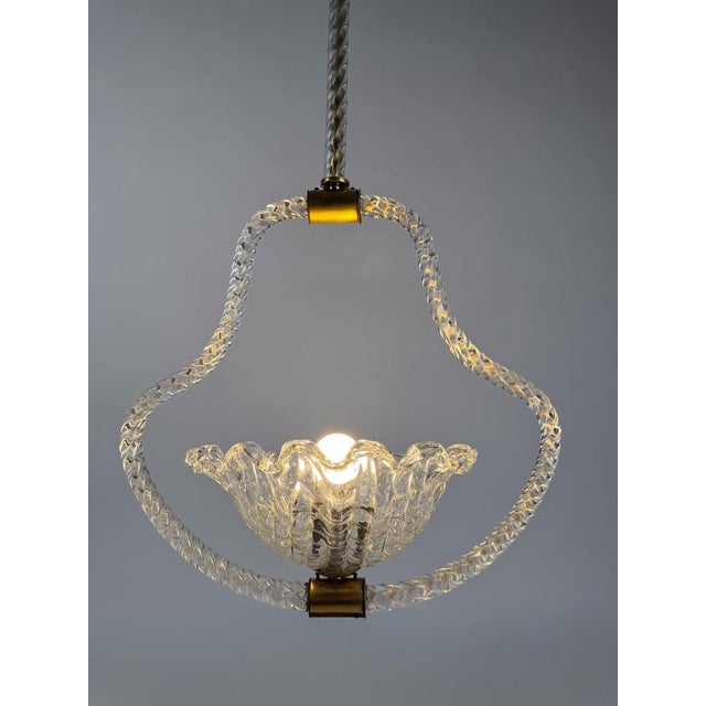 We are pleased to offer this splendid Italian chandelier from the 1930s, handcrafted in clear rostrato Murano glass with...