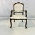 This is a lovely traditional French Provincial style open-armed Bergere Side Chair. The carved wood is walnut with a dark...