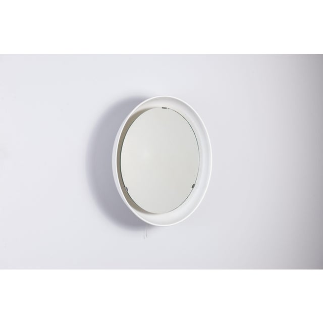 This PH Boudoir Mirror, designed by Poul Henningsen and produced by Louis Poulsen, traces its origins to the 1930s, a...