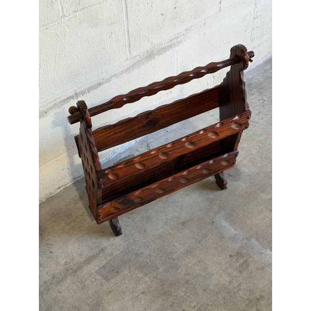 Crafted with rich dark wood, this charming magazine holder features a dual-tier design and a convenient carrying handle....