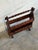 Crafted with rich dark wood, this charming magazine holder features a dual-tier design and a convenient carrying handle....