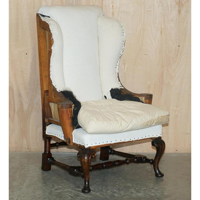 This exquisite pair of Deconstructed Antique Georgian circa 1820 Wingback armchairs with ornately carved cabriole legs and...