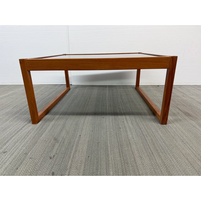 Design Plus Gallery presents a Mid Century Teak and Glass Coffee Table. A simple sled silhouette is crafted from teak and...